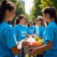A group of volunteers wearing Helping Hands T-shirts distributing food and essential supplies to underprivileged families, symbolizing charity and support.